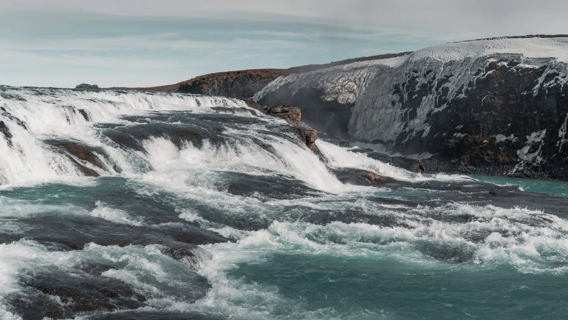 A powerful Icelandic waterfall cascading over dark rocks