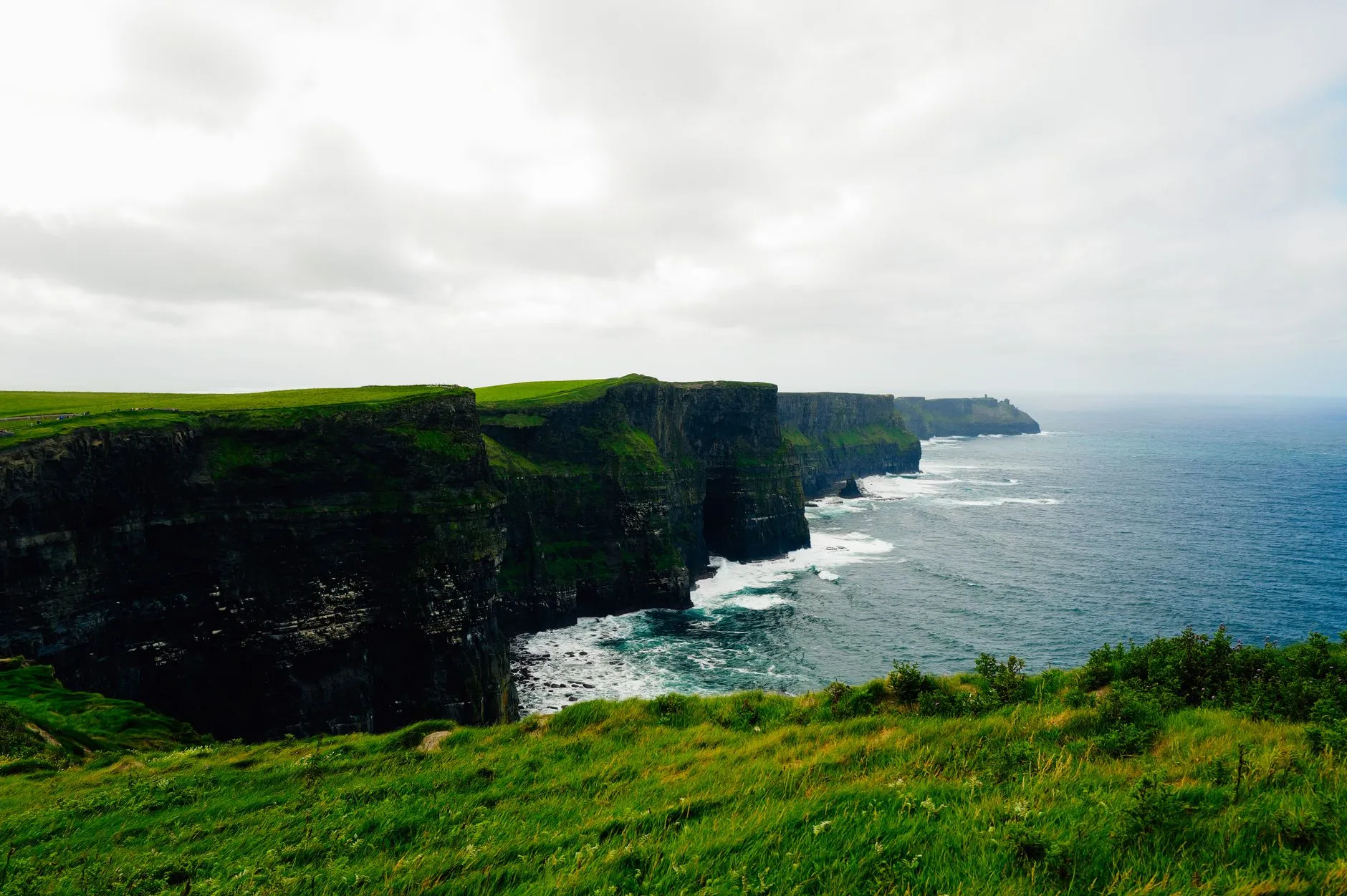 The Cliffs of Moher on Ireland's west coast with green cliffs above the Atlantic